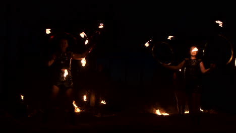 Group-of-fire-jugglers.-People-spit-fire-in-a-dark-night-outdoors-performance.